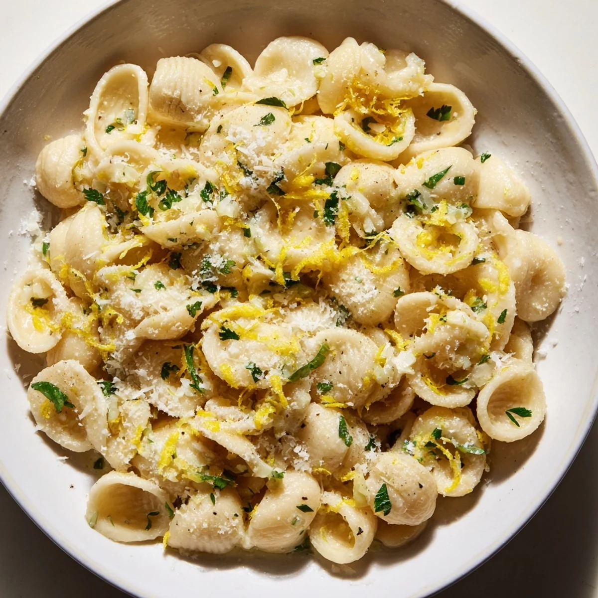 Steaming bowl of 15-Minute Creamy Garlic Butter Ditalini, garnished with fresh parsley and Parmesan cheese.