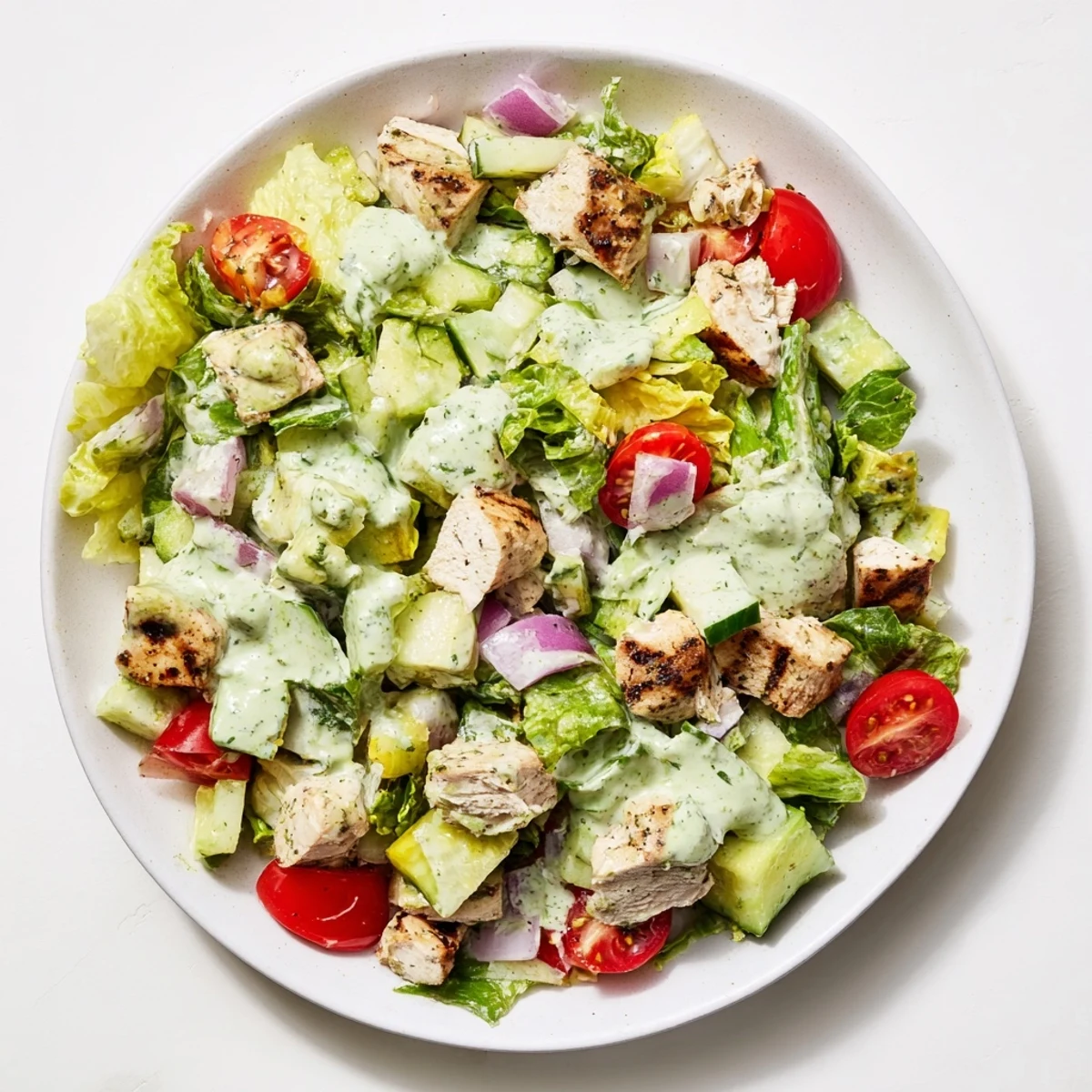 Golden-brown chicken chunks tossed in avocado ranch dressing with fresh vegetables, perfect for a light and healthy lunch.  