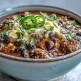 Taco Soup simmering in a large pot with visible beans, corn, and diced tomatoes for a family meal.
