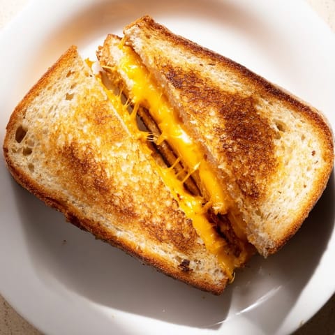 Enjoy a spicy-sweet bite of this Honey Chipotle Butter Grilled Cheese, grilled to crispy perfection.