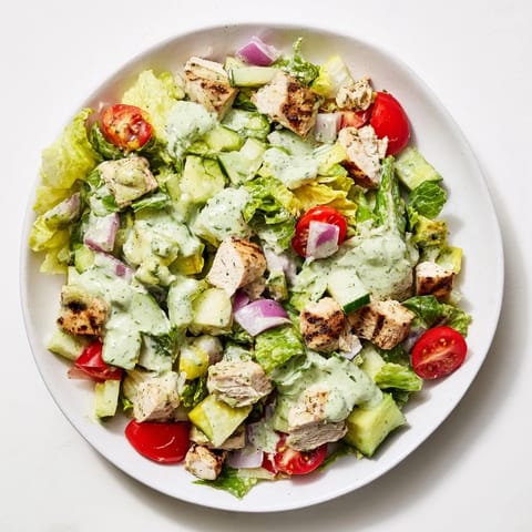 Golden-brown chicken chunks tossed in avocado ranch dressing with fresh vegetables, perfect for a light and healthy lunch.  
