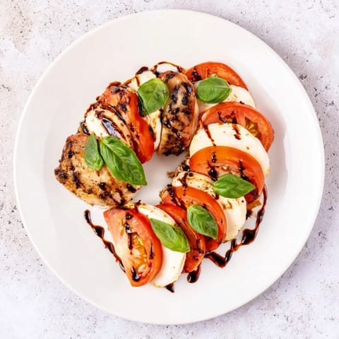 Caprese Chicken Skillet served alongside a crisp green salad and crusty bread.